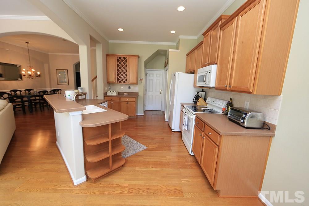 6822 Middleboro Drive Raleigh, NC 27612 - Photo 5 of 13 a large kitchen with stainless steel appliances granite countertop a stove and a refrigerator