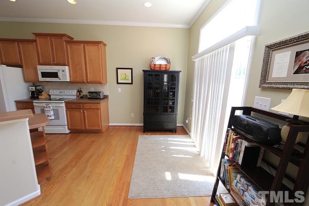 6822 Middleboro Drive Raleigh, NC 27612 - Photo 6 of 13 a view of a kitchen with a sink stove and wooden floor