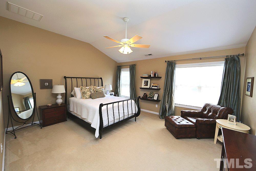 6822 Middleboro Drive Raleigh, NC 27612 - Photo 7 of 13 a bedroom with bed and a chandelier