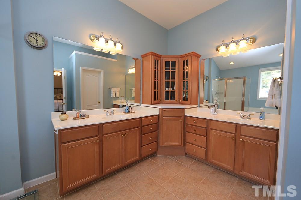 6822 Middleboro Drive Raleigh, NC 27612 - Photo 8 of 13 a spacious bathroom with a double vanity sink and a mirror