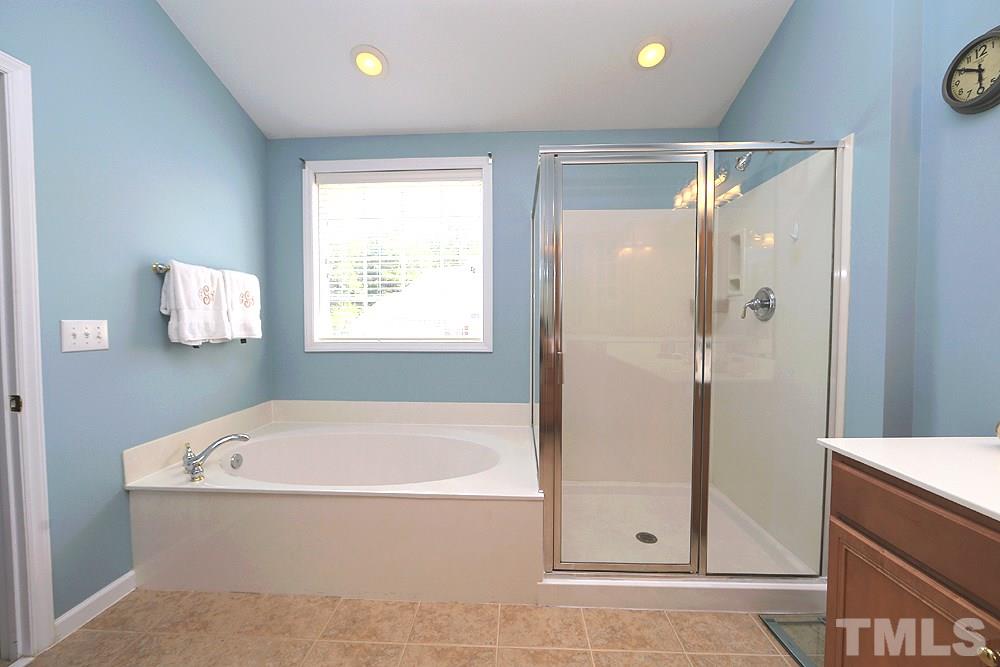 6822 Middleboro Drive Raleigh, NC 27612 - Photo 9 of 13 a white bath tub sitting in a bathroom and shower