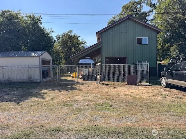 a view of a house with a yard and garage