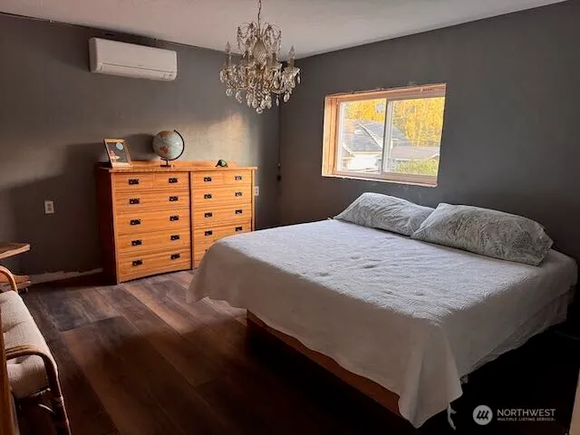 a bedroom with a bed and a chandelier
