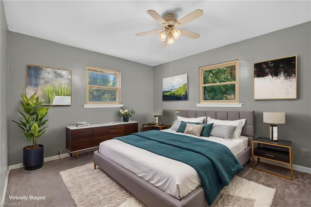 113 Green Valley Road Greensboro, NC 27403 - Photo 6 of 46 The primary bedroom provides a peaceful retreat with plenty of room to unwind at the end of the day. (Virtually Staged)
