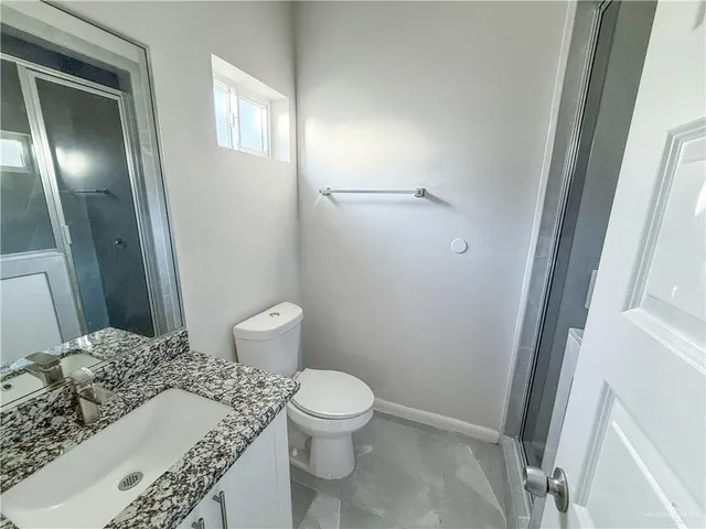 a bathroom with a toilet and a mirror