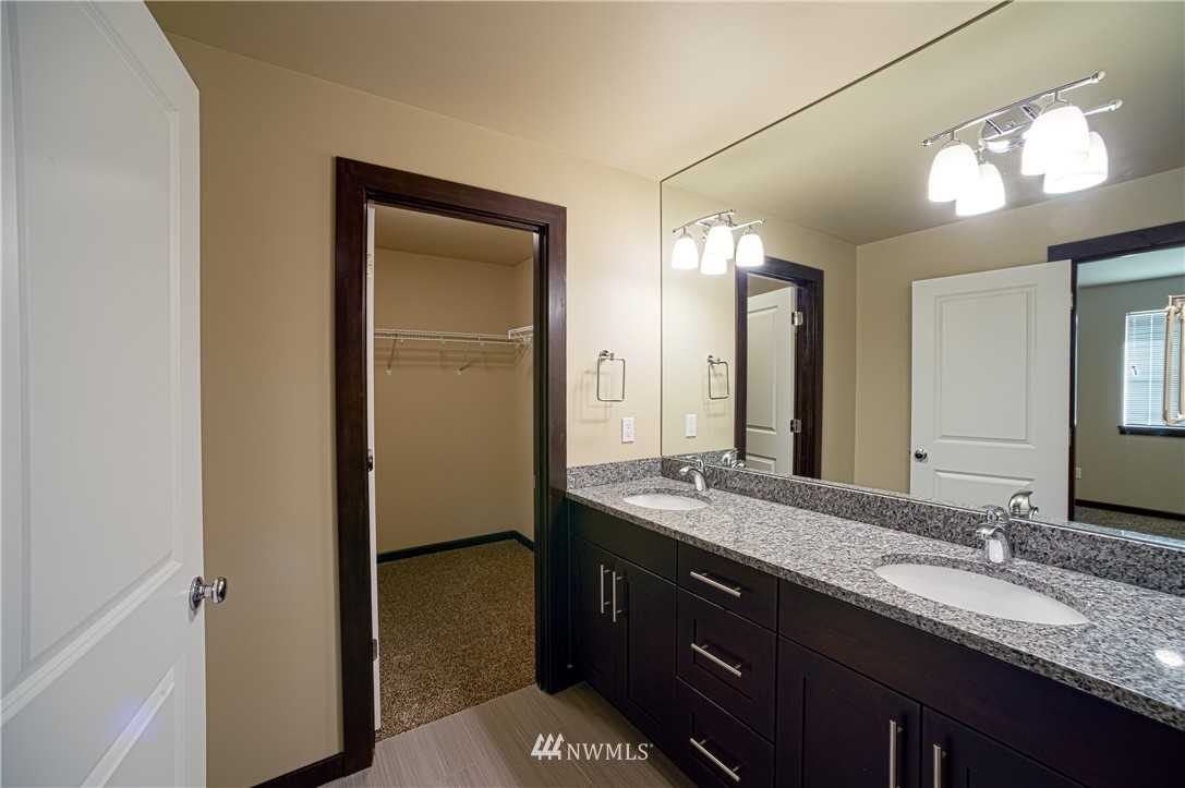 604 Morris Avenue South Renton, WA 98057 - Photo 12 of 21 a bathroom with a granite countertop sink and a mirror