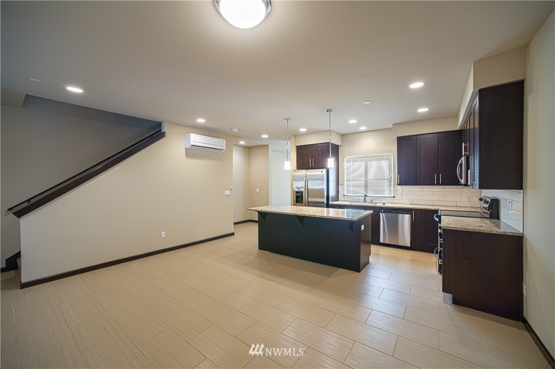 604 Morris Avenue South Renton, WA 98057 - Photo 3 of 21 a large kitchen with stainless steel appliances kitchen island granite countertop a large counter top and oven