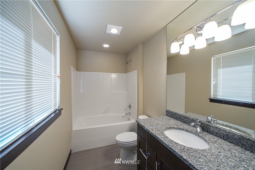 604 Morris Avenue South Renton, WA 98057 - Photo 5 of 21 a bathroom with a granite countertop sink toilet and shower
