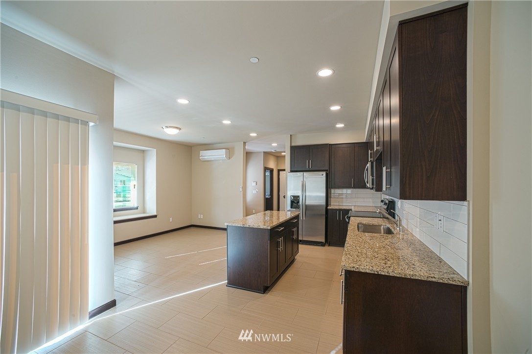 604 Morris Avenue South Renton, WA 98057 - Photo 10 of 21 a open kitchen with stainless steel appliances granite countertop a refrigerator and a sink