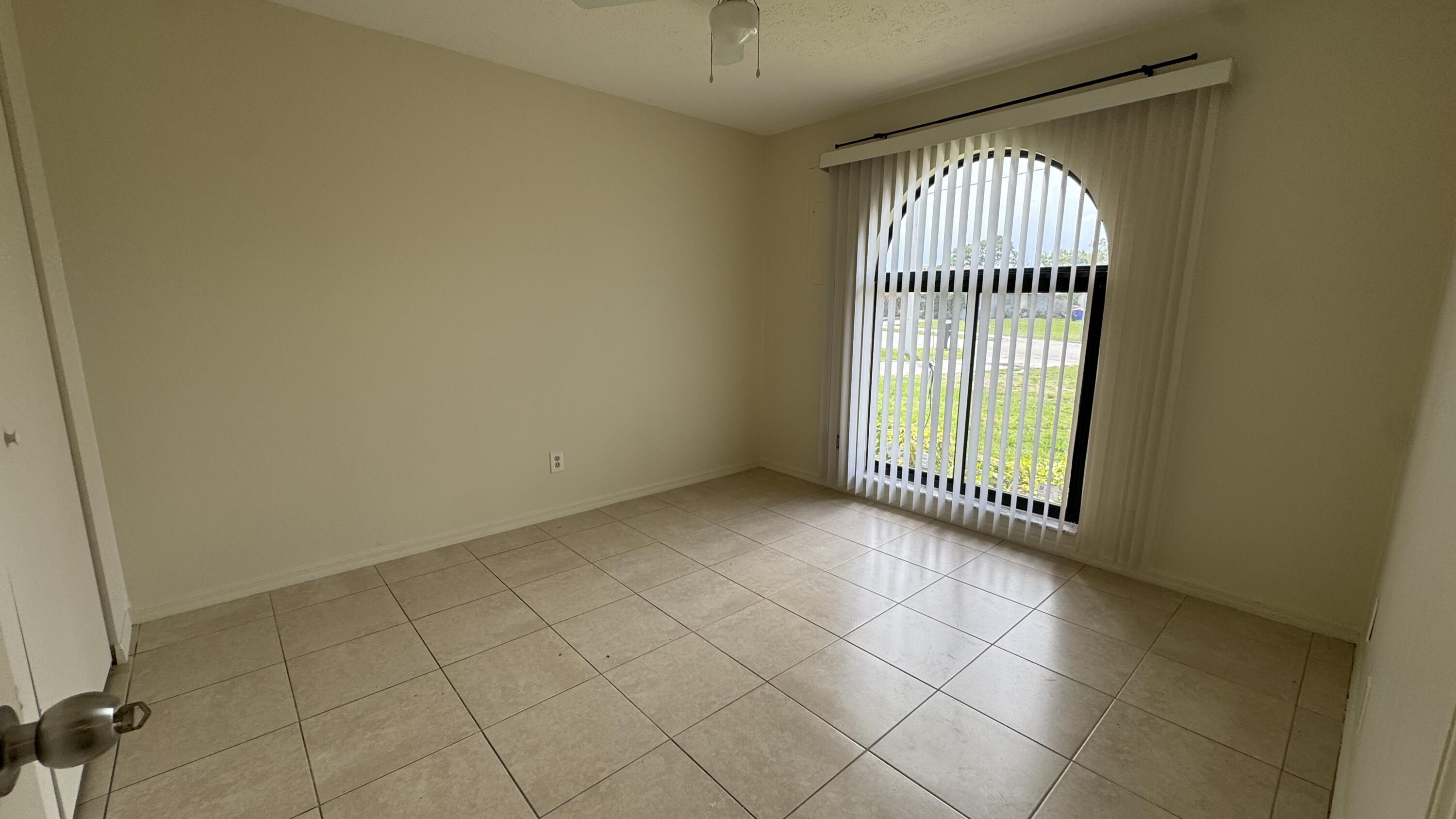 5045 Southeast Primrose Way Stuart, FL 34997 - Photo 5 of 6 an empty room with windows