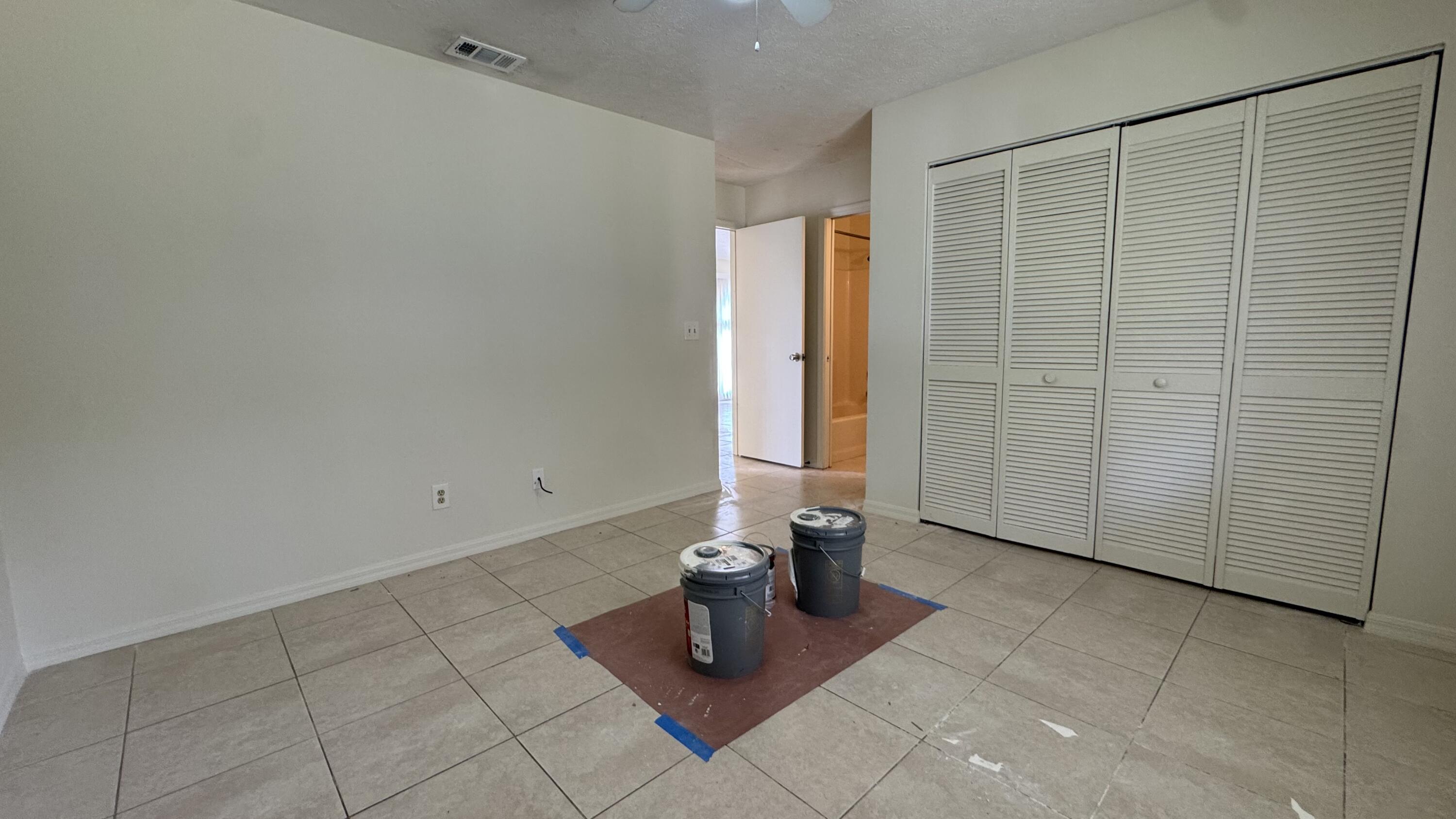 5045 Southeast Primrose Way Stuart, FL 34997 - Photo 6 of 6 an empty room with glass door