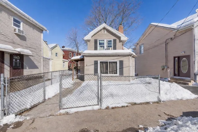 a view of a white house with large windows