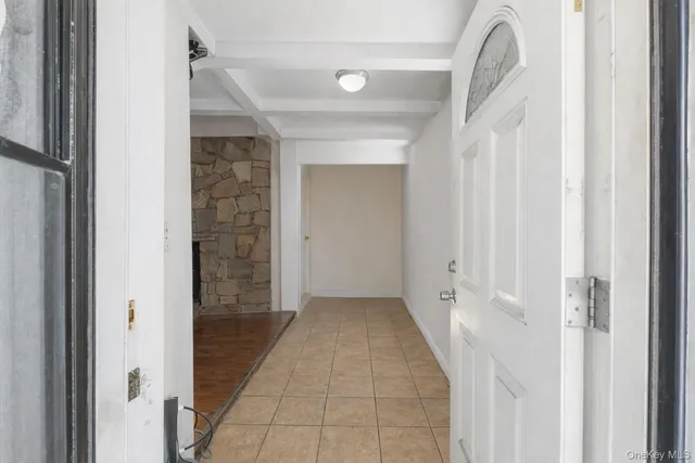 a view of a hallway with wooden floor and entryway