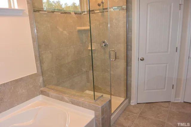 a bathroom with a bathtub and shower