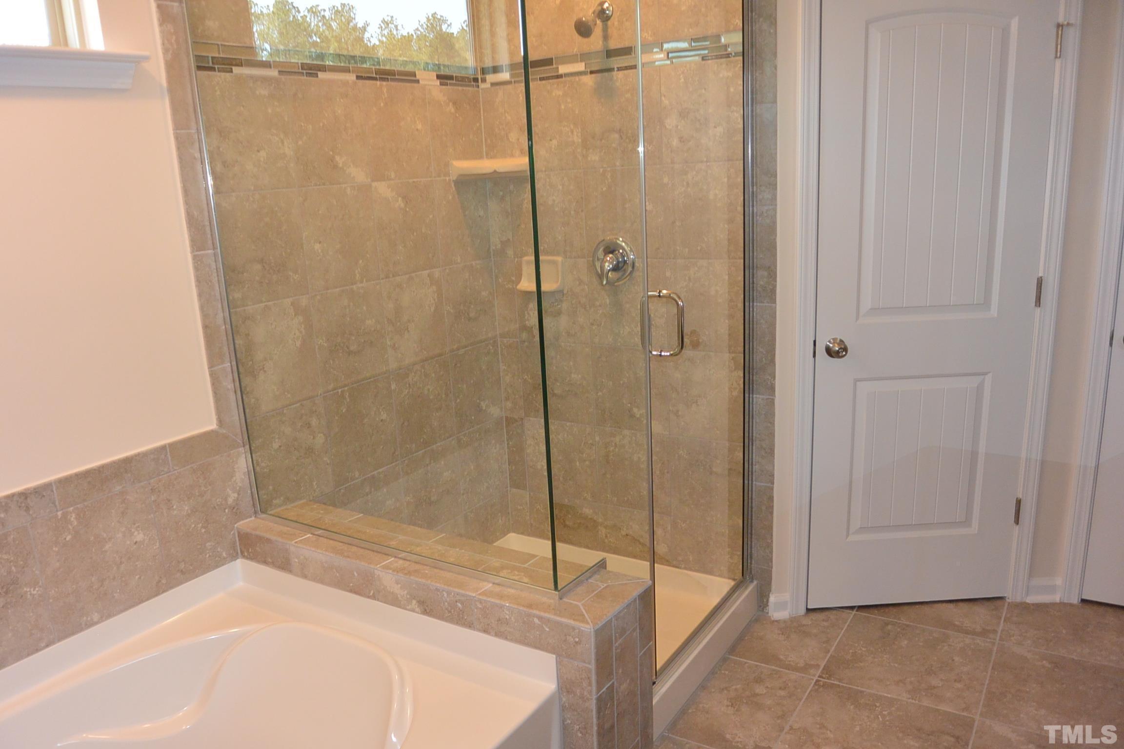 249 Tilth Street Cary, NC 27519 - Photo 14 of 18 a bathroom with a bathtub and shower