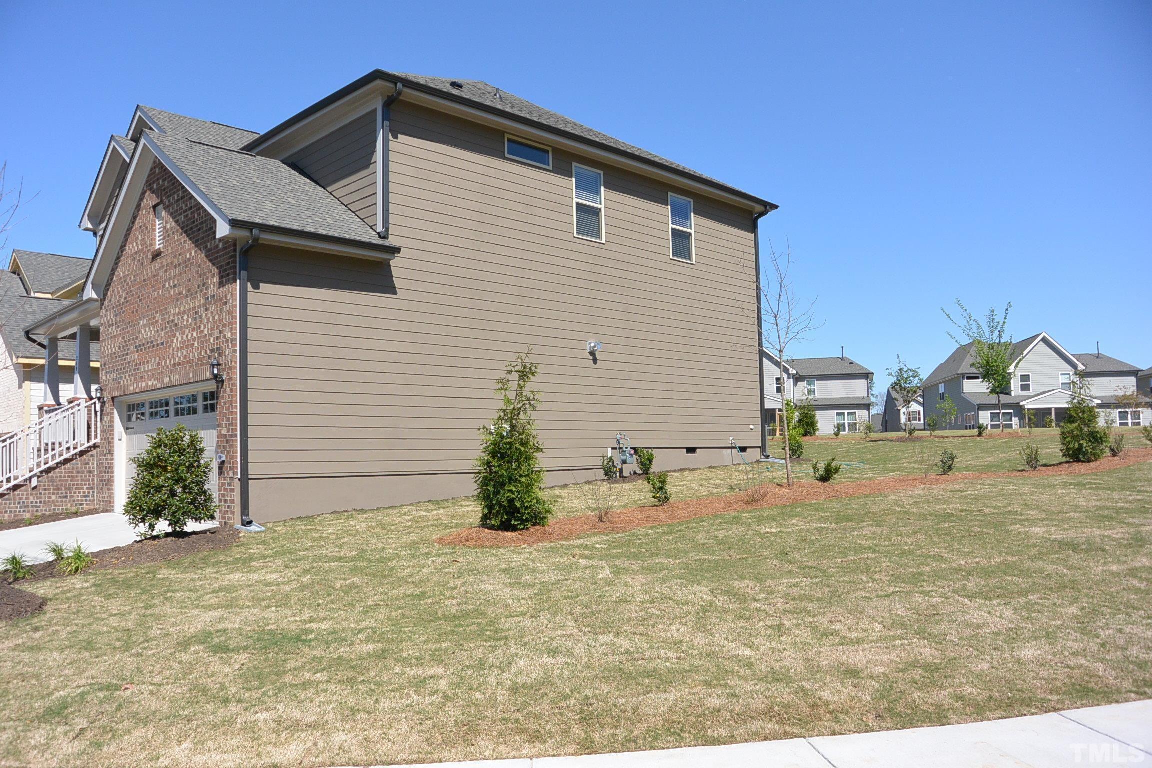 249 Tilth Street Cary, NC 27519 - Photo 2 of 18 a view of a house with a yard