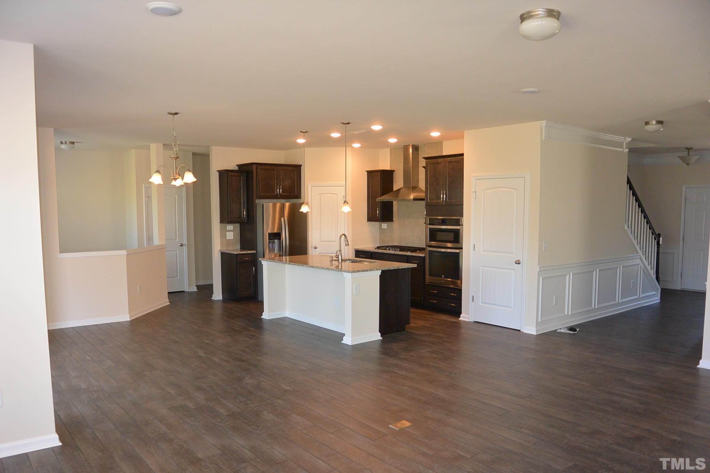 249 Tilth Street Cary, NC 27519 - Photo 8 of 18 a view of a kitchen with refrigerator and wooden floor