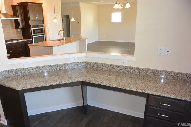 a kitchen with a sink and a mirror