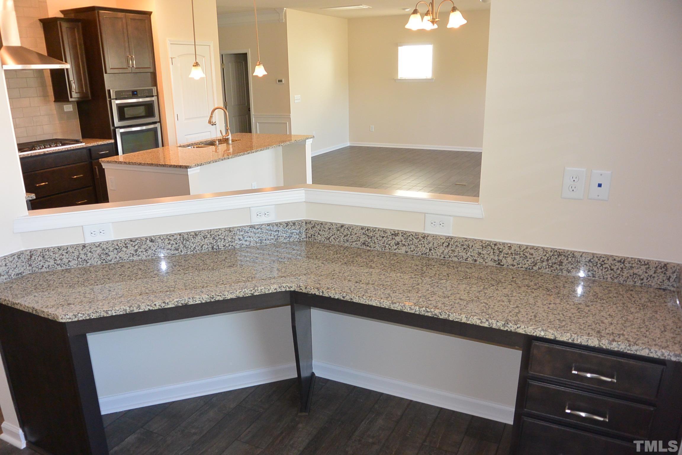 249 Tilth Street Cary, NC 27519 - Photo 10 of 18 a kitchen with a sink and a mirror