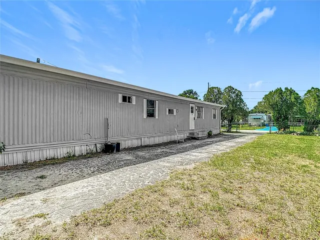 a view of a balcony with wooden floor and outdoor seating