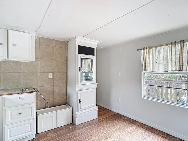 a bathroom with a sink a toilet and a window