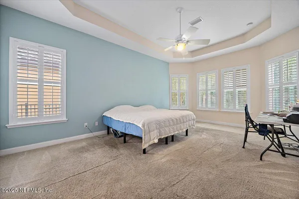 a spacious bedroom with a bed and a table in it