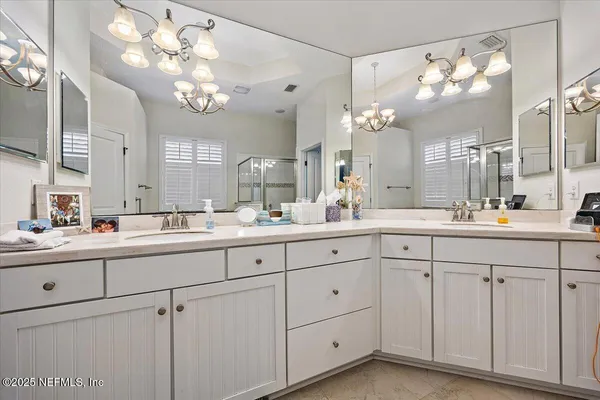 a bathroom with a sink vanity and a mirror