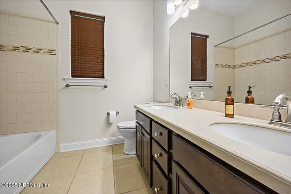 a bathroom with a sink a toilet and bathtub