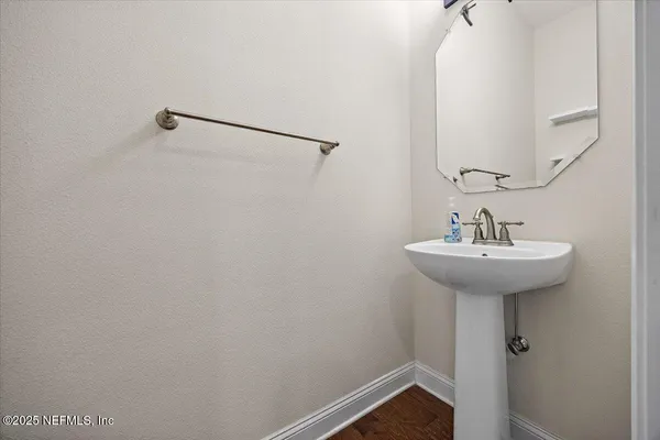 a bathroom with a sink and mirror
