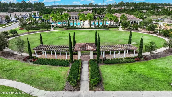 a view of a garden with a house in the background
