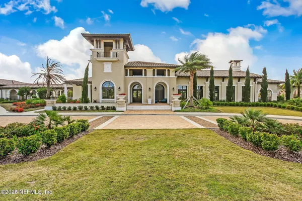 a front view of a building with a garden