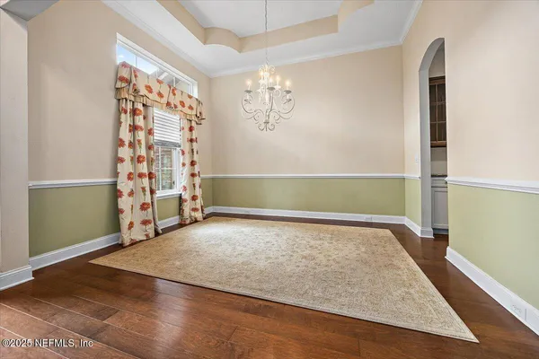 a view of an empty room with window and cabinet