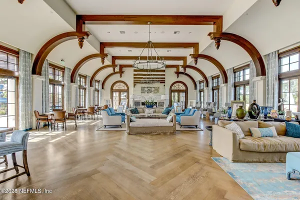 a living room with fireplace furniture and a large window