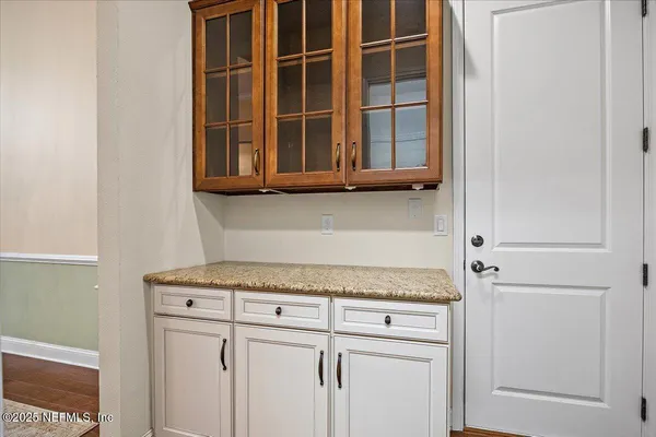 a kitchen with a granite countertop cabinets and a refrigerator