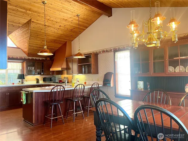 a view of a dining room with furniture and a window