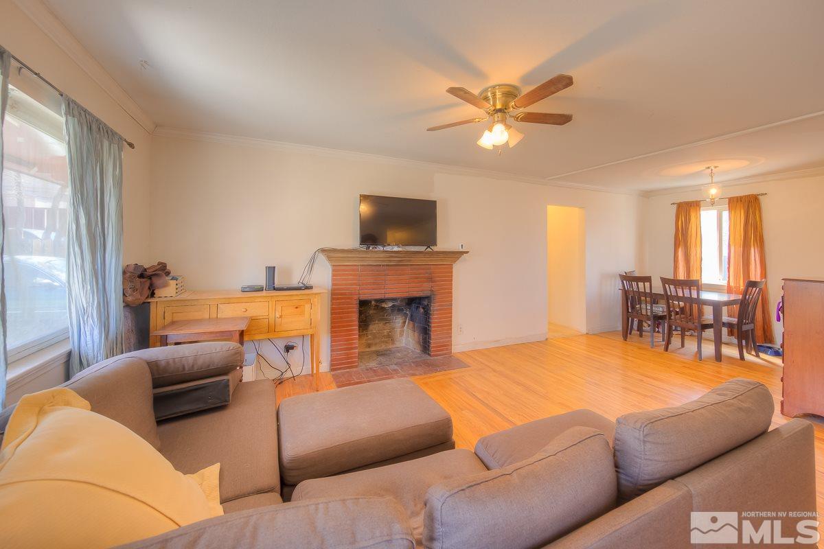 895 Cherry Lane Reno, NV 89509 - Photo 3 of 26 a living room with furniture a fireplace and a flat screen tv