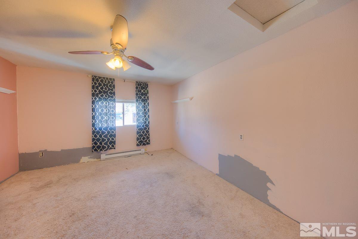 895 Cherry Lane Reno, NV 89509 - Photo 8 of 26 en empty room with windows and chandelier fan