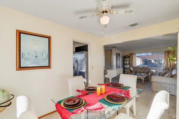 a view of a dining room with furniture wooden floor and a chandelier