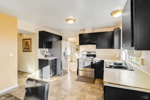a kitchen with a sink stainless steel appliances and cabinets