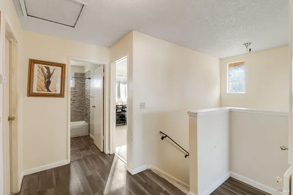 a view of a hallway with wooden floor and entryway