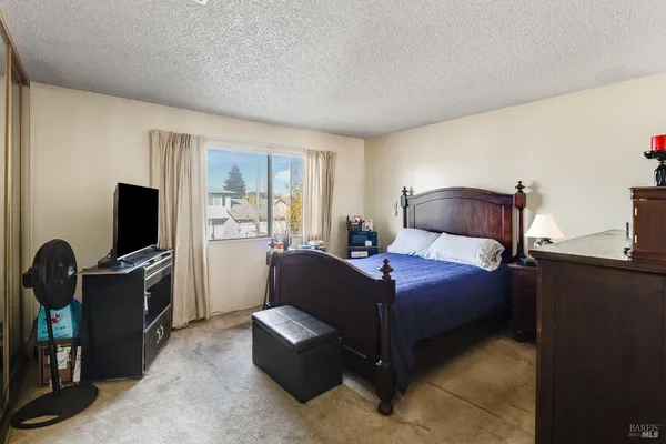 a bedroom with a bed and a flat screen tv