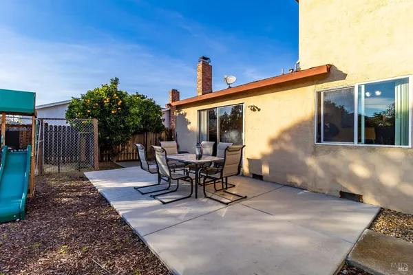a view of a patio with a table and chairs