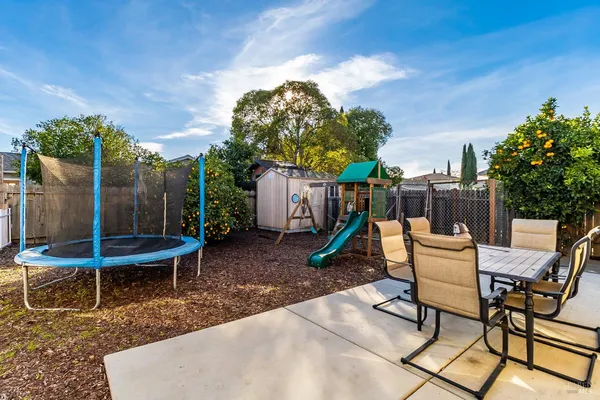 a view of a chairs and tables in the backyard