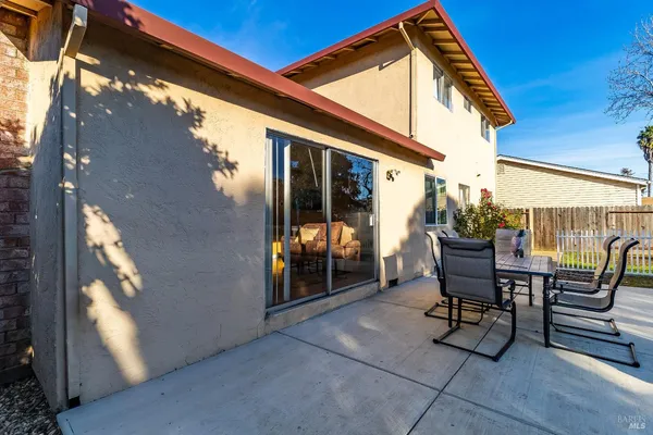 a patio with table and chairs