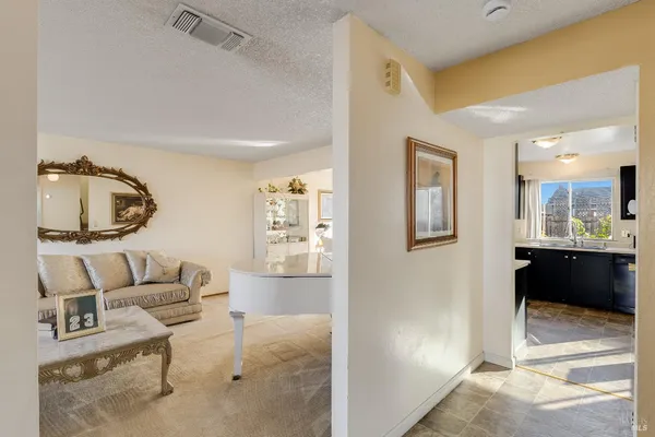 a living room with furniture and a view of bathroom