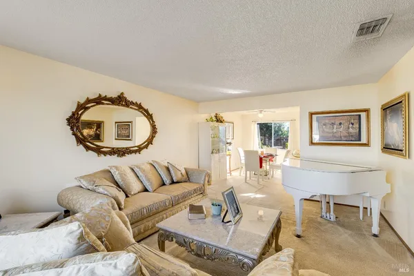 a living room with furniture and a mirror