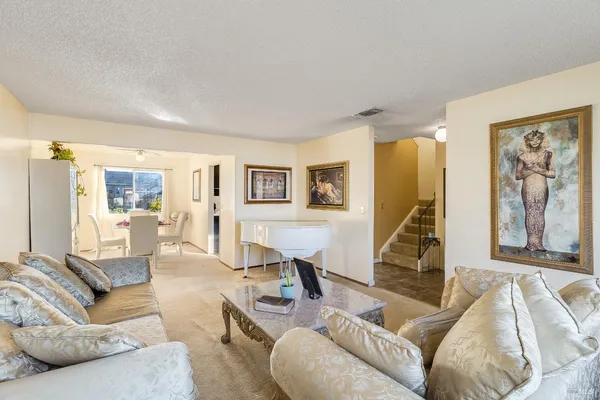 a living room with furniture a wooden floor and a large window