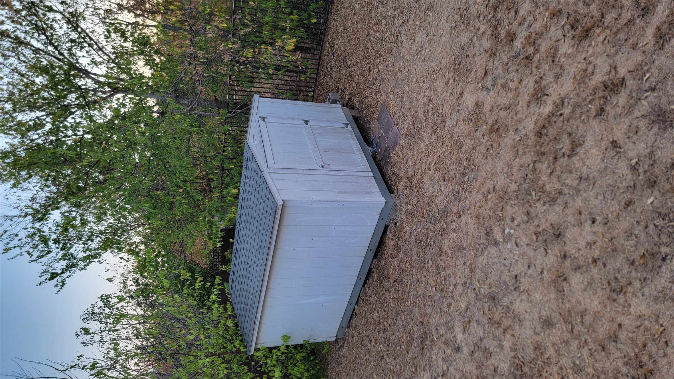 10528 Dunham Forest Road Austin, TX 78717 - Photo 12 of 12 A quaint storage shed offers convenient organization for outdoor essentials within a fenced yard.