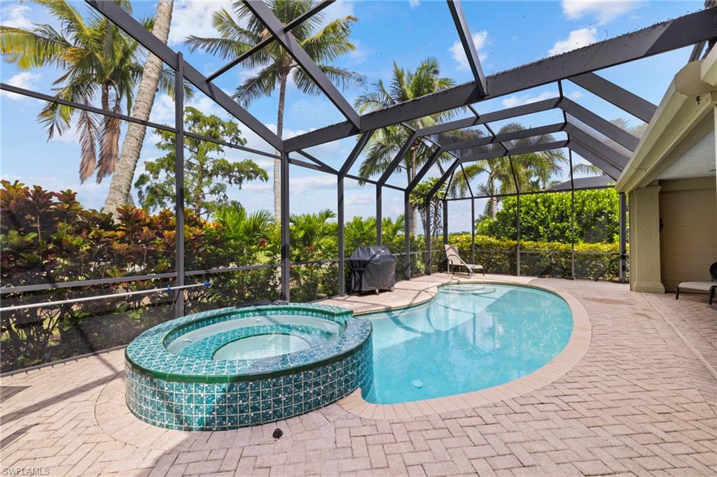 6903 Mauna Loa Lane Naples, FL 34113 - Photo 3 of 46 a view of a swimming pool with a patio