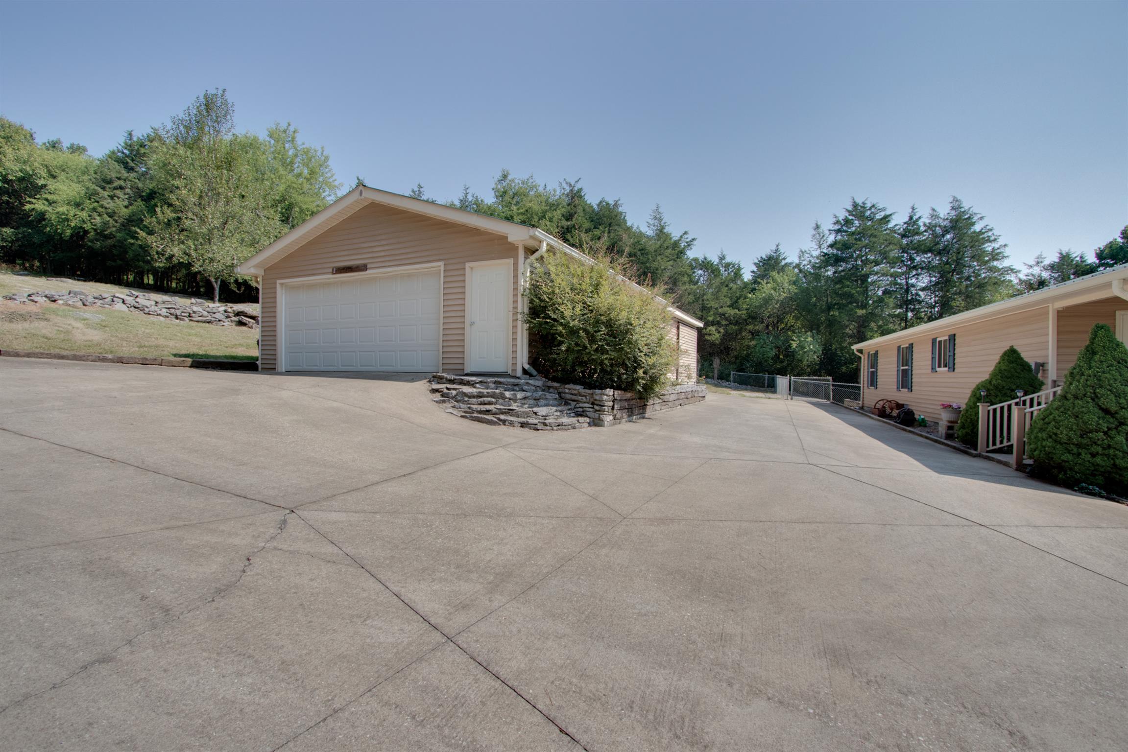 200 East Buffalo Road Carthage, TN 37030 - Photo 24 of 30 a view of a house with a yard and potted plants